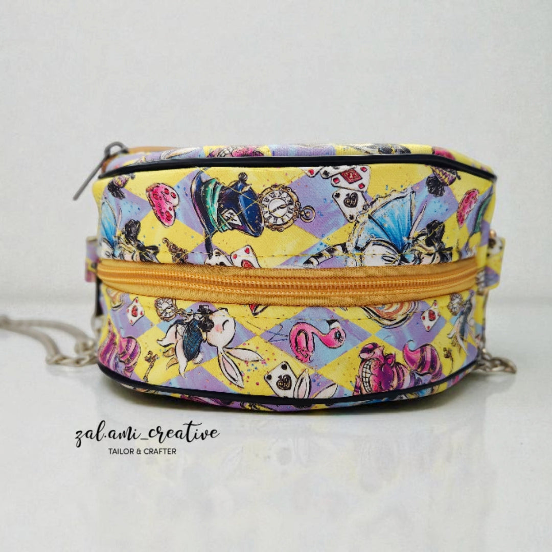 Colorful patterned bag with a yellow zipper on a white background. PDF pattern.