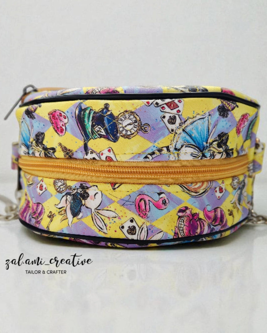 Colorful patterned bag with a yellow zipper on a white background. PDF pattern.