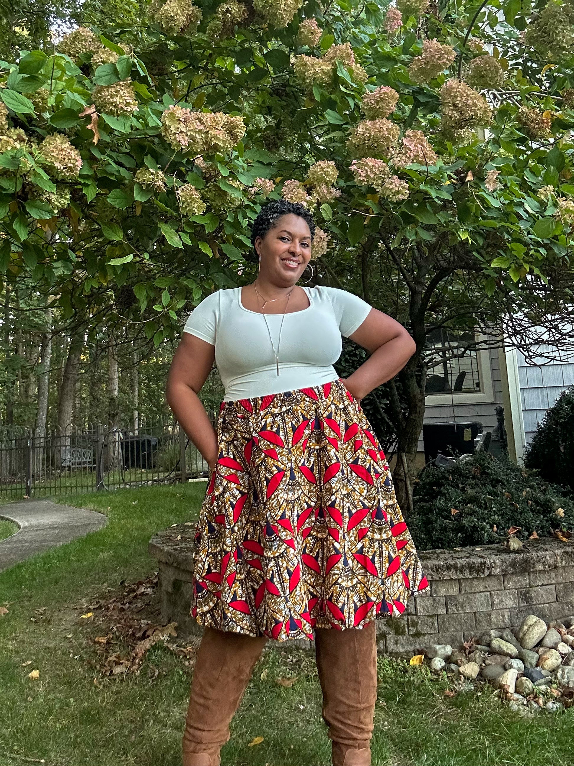 Woman in a patterned skirt standing outdoors with greenery in the background. The skirt is made using the Sadie Bubble Skirt PDF sewing pattern. It includes a projector file, A0 copyshop file, and A4 and Letter print file. Full-length sew-along video tutorial is included.