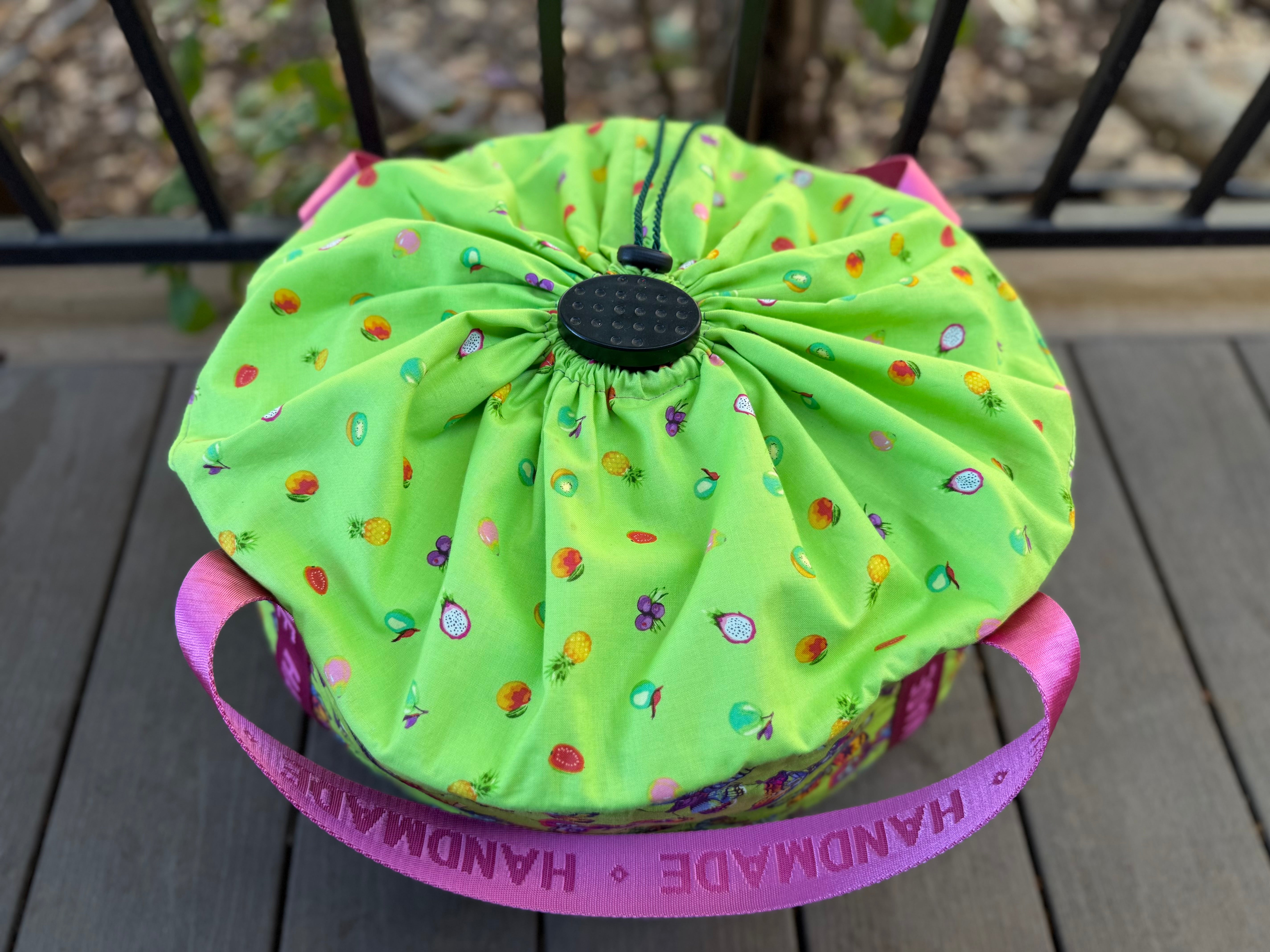 Top view of the Green slow cooker carrier. Shows a drawstring top part with colorful patterns on a wooden surface. Easy to open and display your slow cooker without removing the bag.