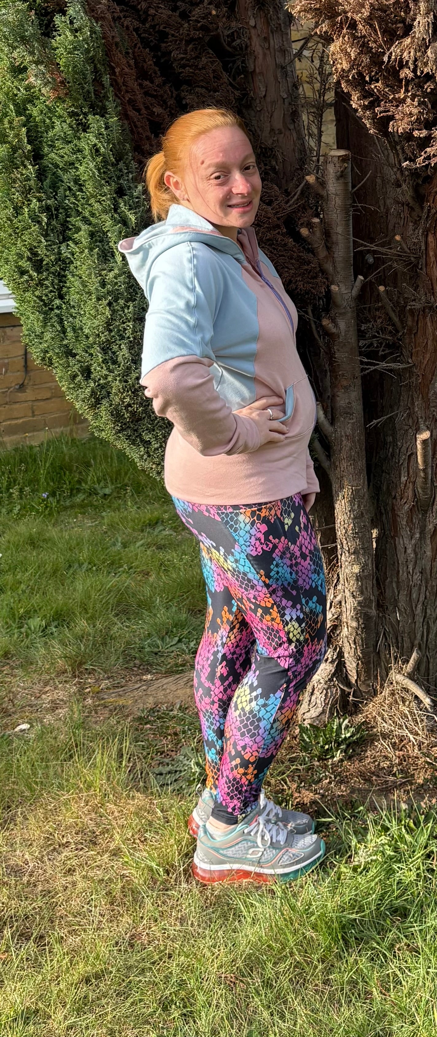 Woman modeling light pink and light blue color-blocked hooded jacket zip closure. High hip length. Video tutorial sewing.