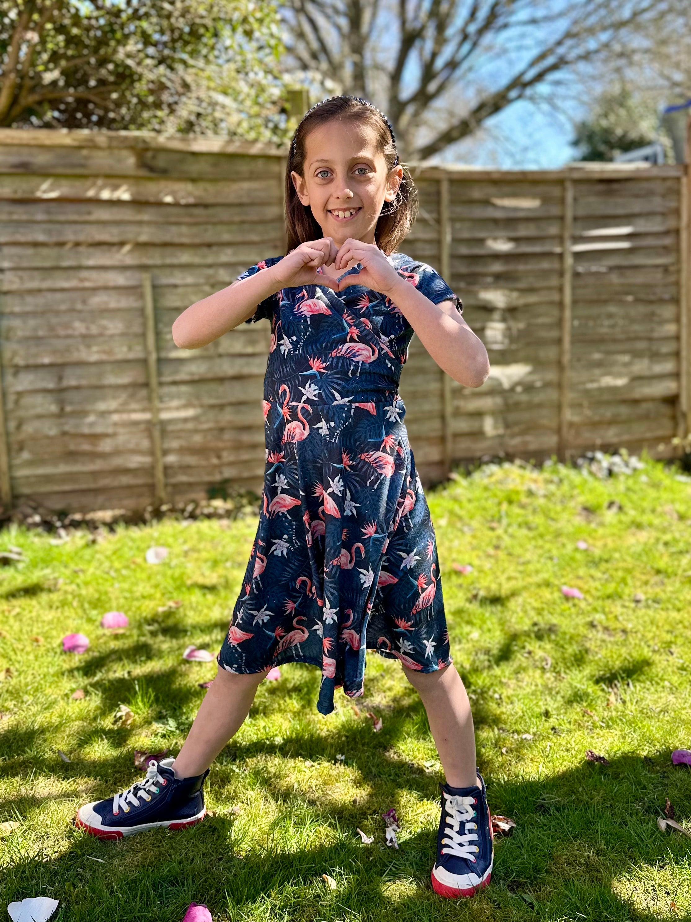 Flamingo fabric kids short sleeve summer dress made using Tres Belle Dress sewing pattern by Ellie and Mac Patterns.