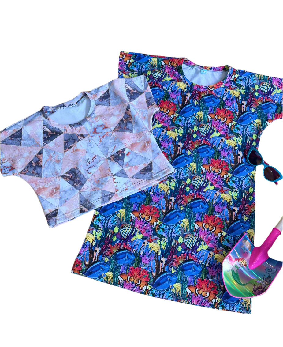A patterned crop top and dress with a colorful shovel and sunglasses.