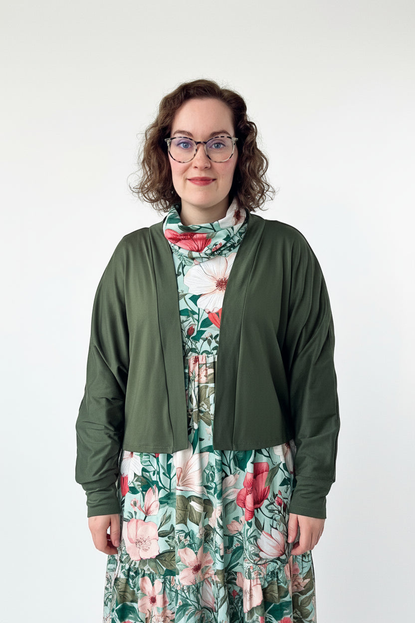 Woman wearing a long sleeve batwing cardigan sewing project in olive green knit french terry fabric.