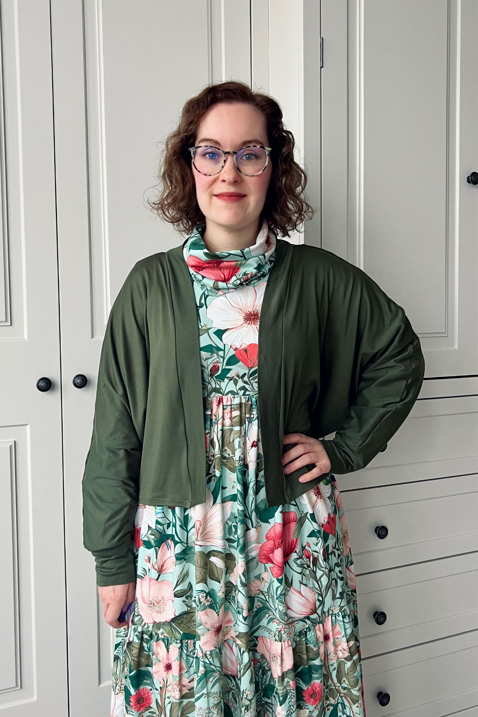 Woman wearing a long sleeve batwing cardigan sewing project in olive green knit french terry fabric.