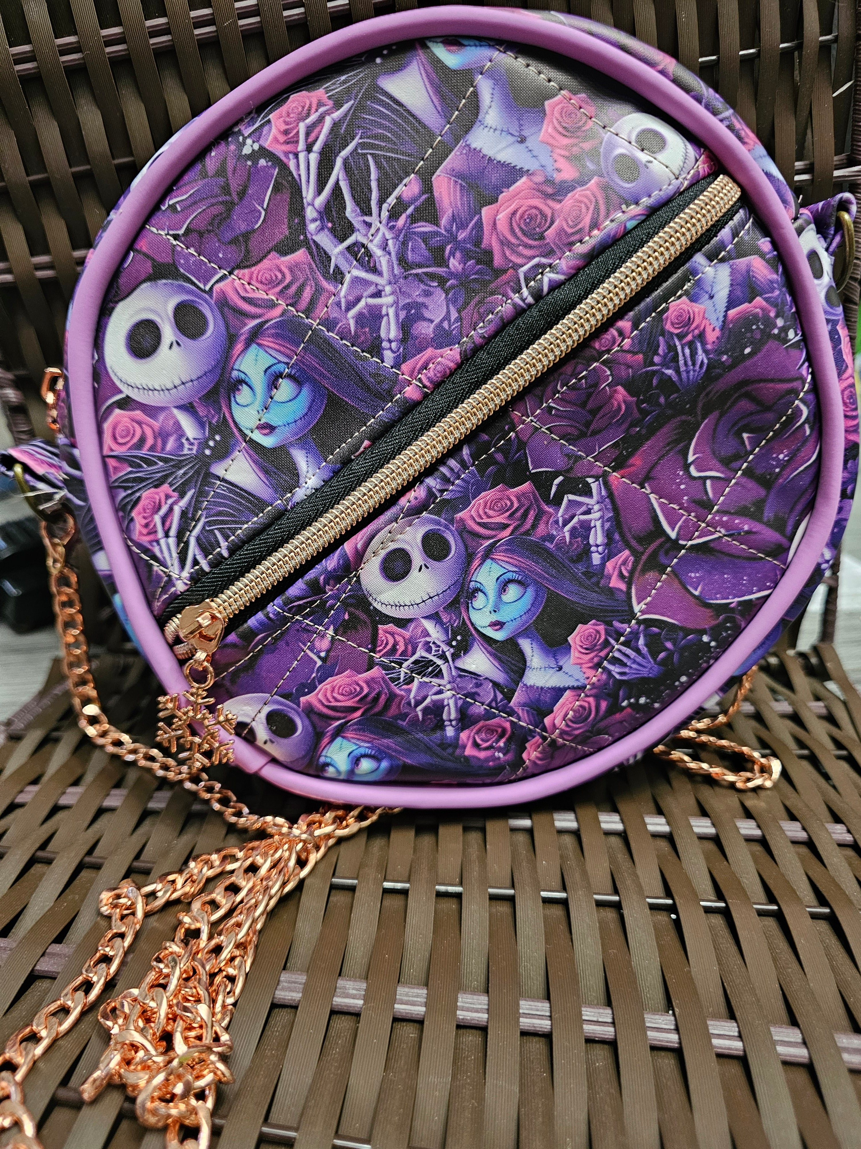 Round purple bag with character design on a woven surface