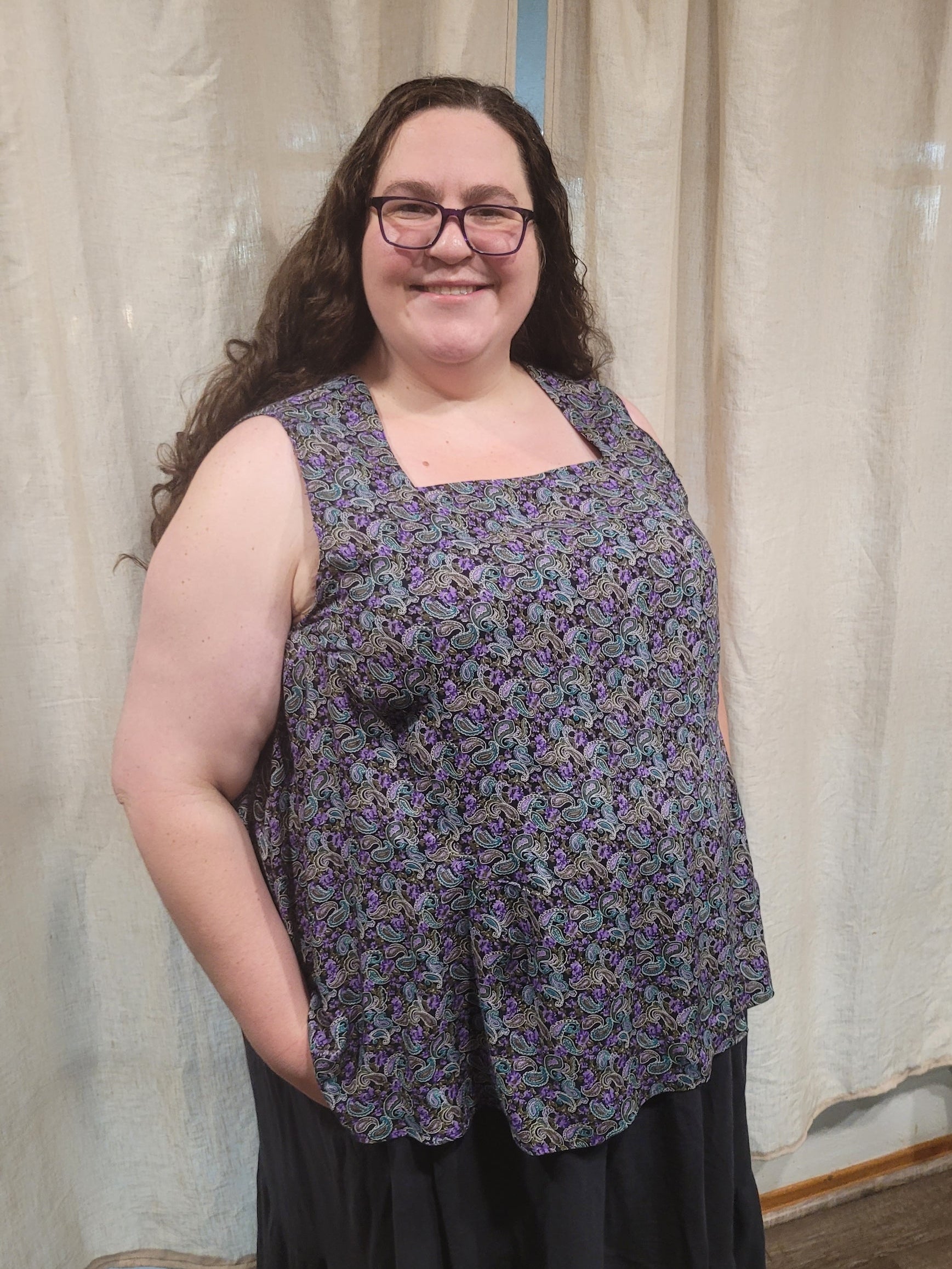 Sleeveless woven blouse paired with a skirt for chic outfit