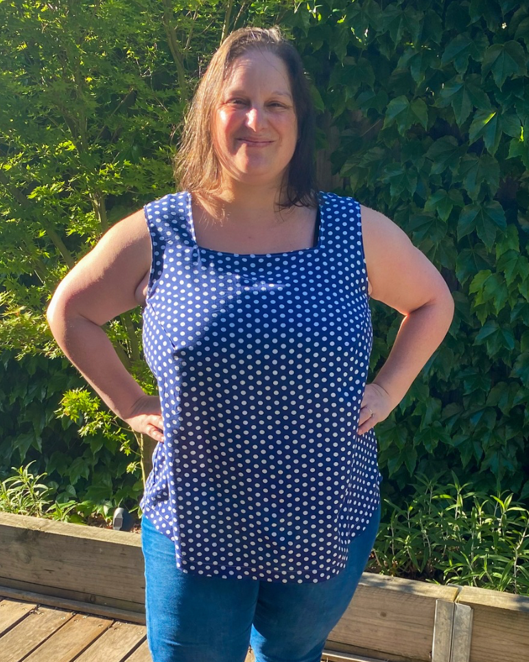 Sleeveless woven blouse paired with trousers for chic outfit