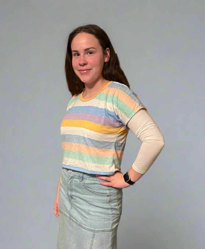 Girl modeling a striped crop top dolman sewing pattern for kids by Ellie and Mac sewing patterns.