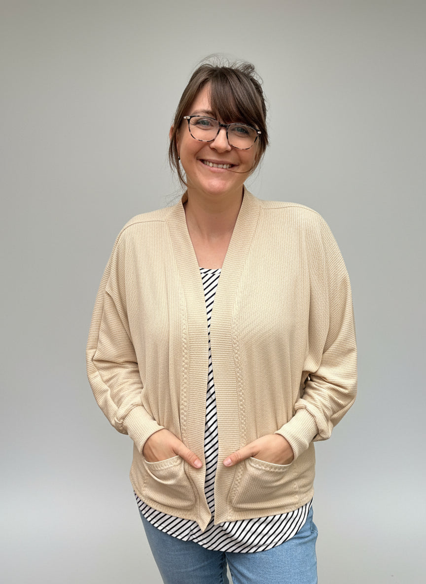 Relaxed knit cardigan layered over casual wardrobe staples