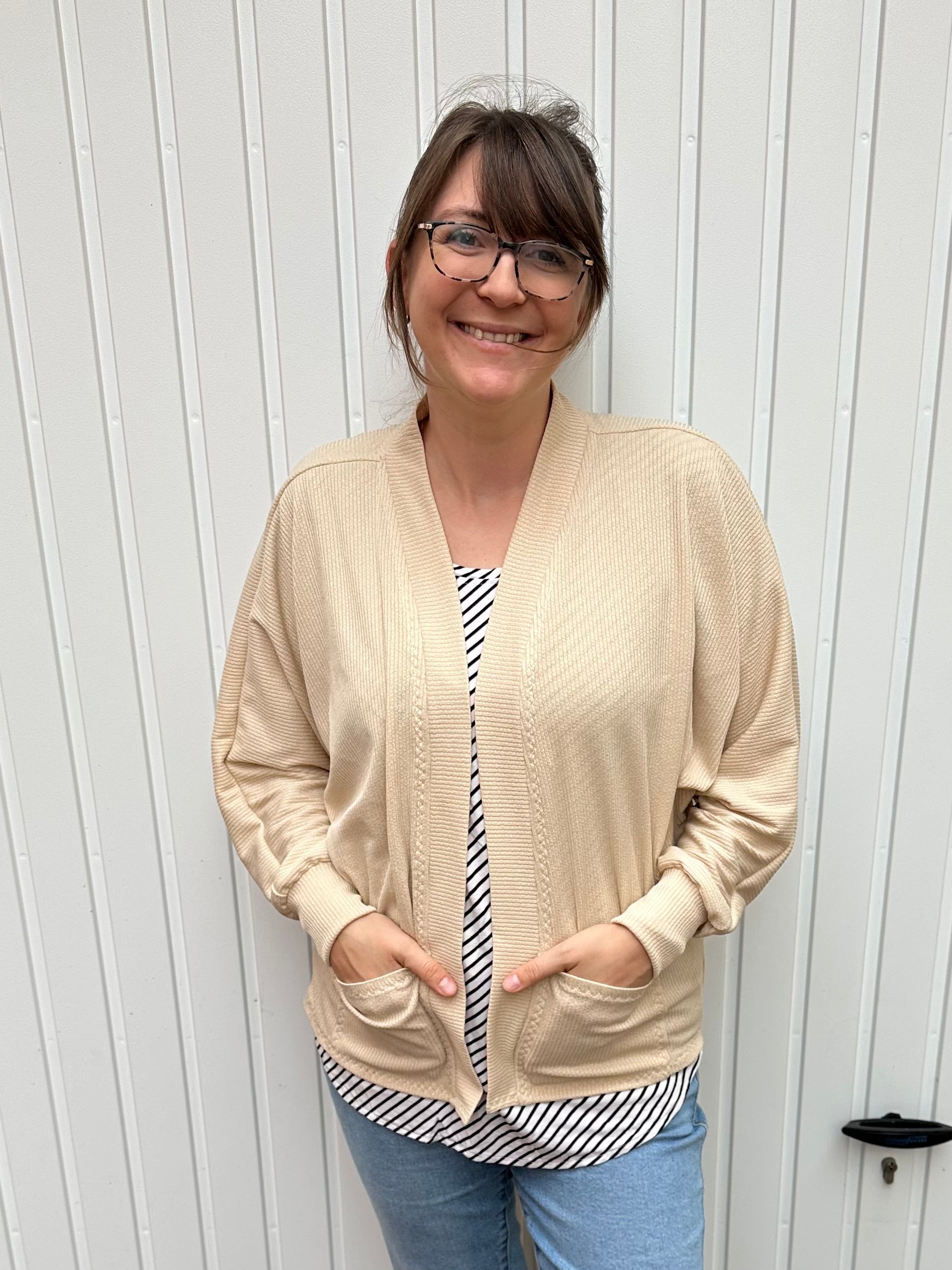 Relaxed knit cardigan layered over casual wardrobe staples