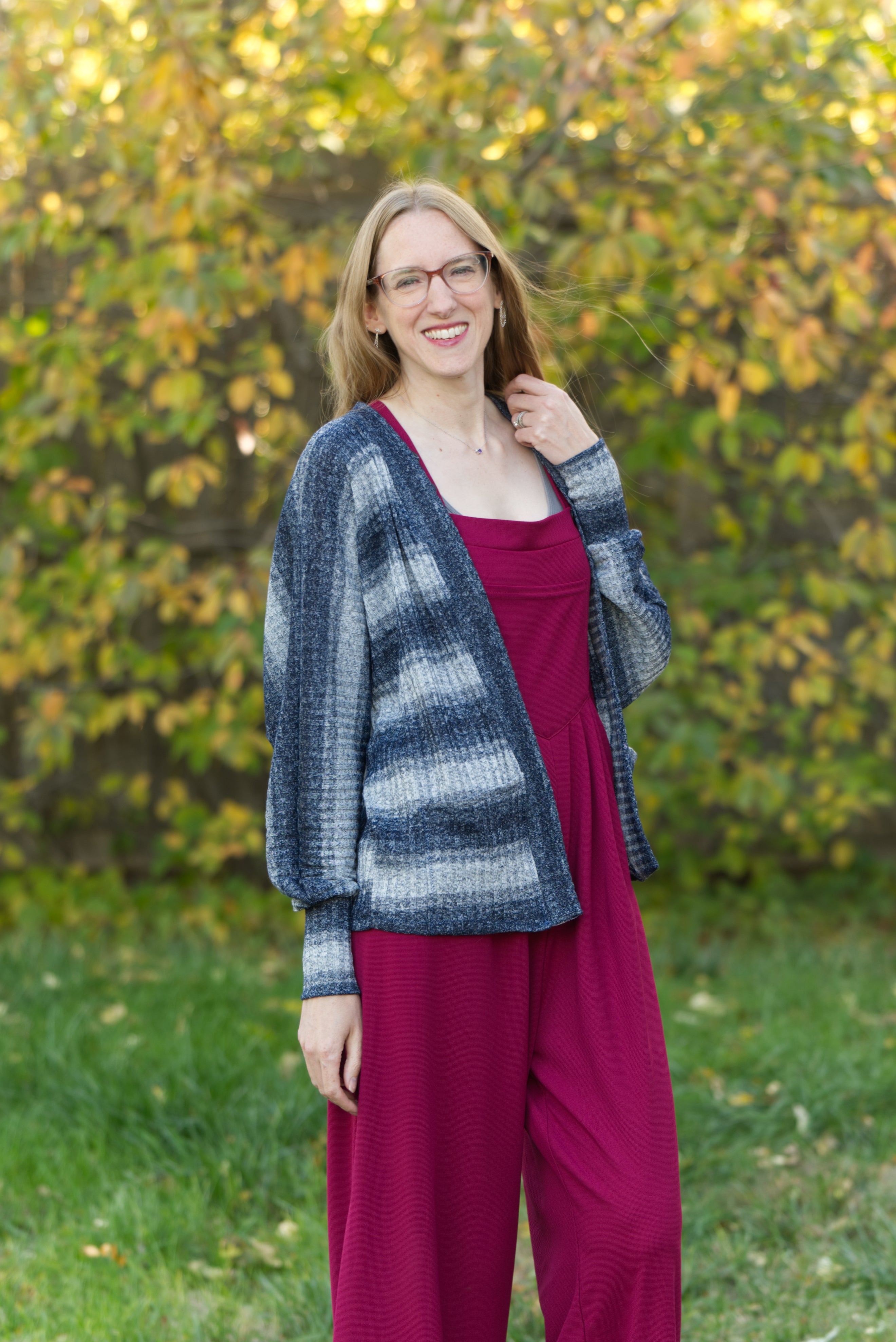 Woman wearing a Lightweight knit cardigan sewing pattern with modern shape standing outside.