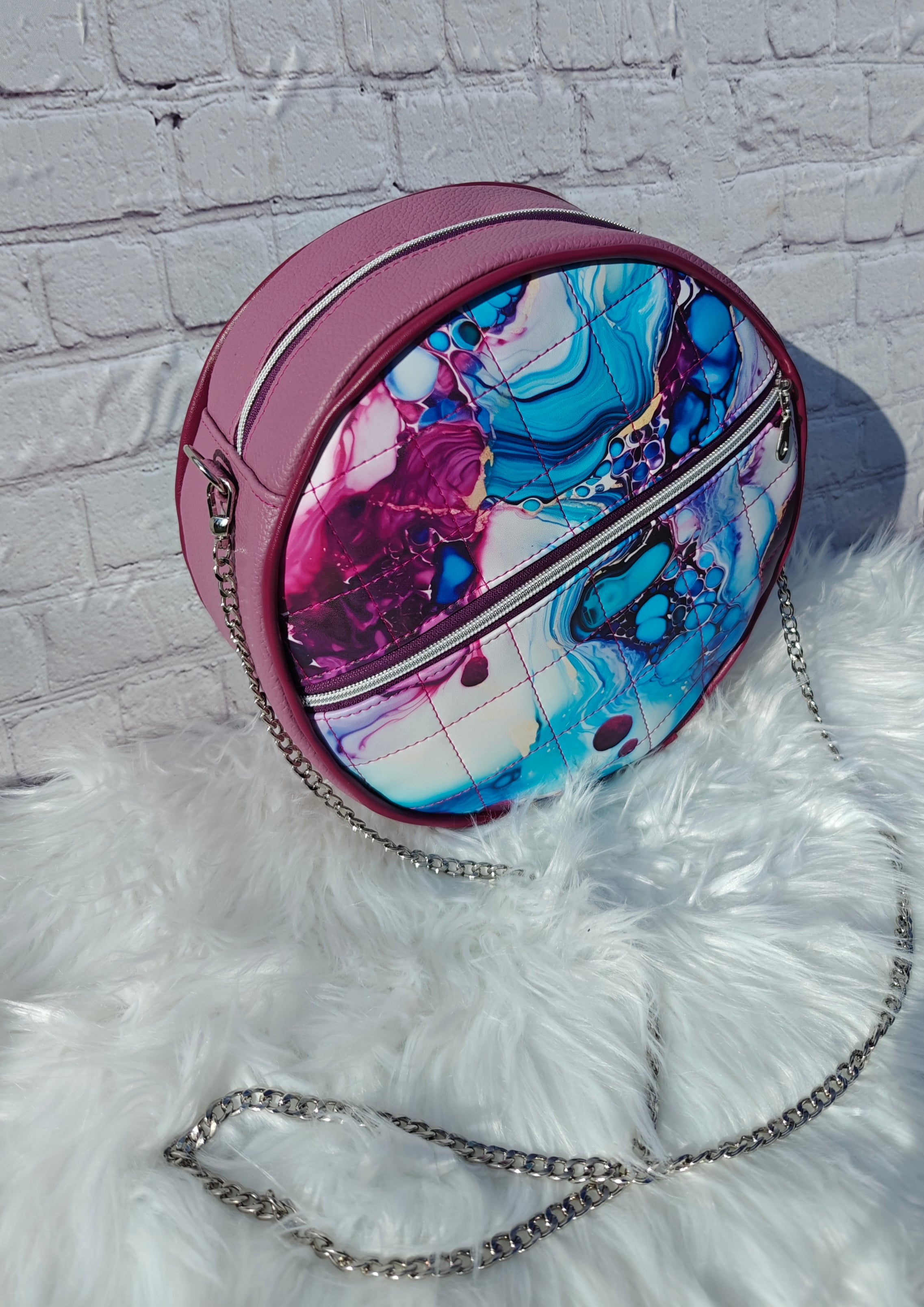 Ellie Essential Round Bag sewing pattern in teal marble faux leather with metal piping.