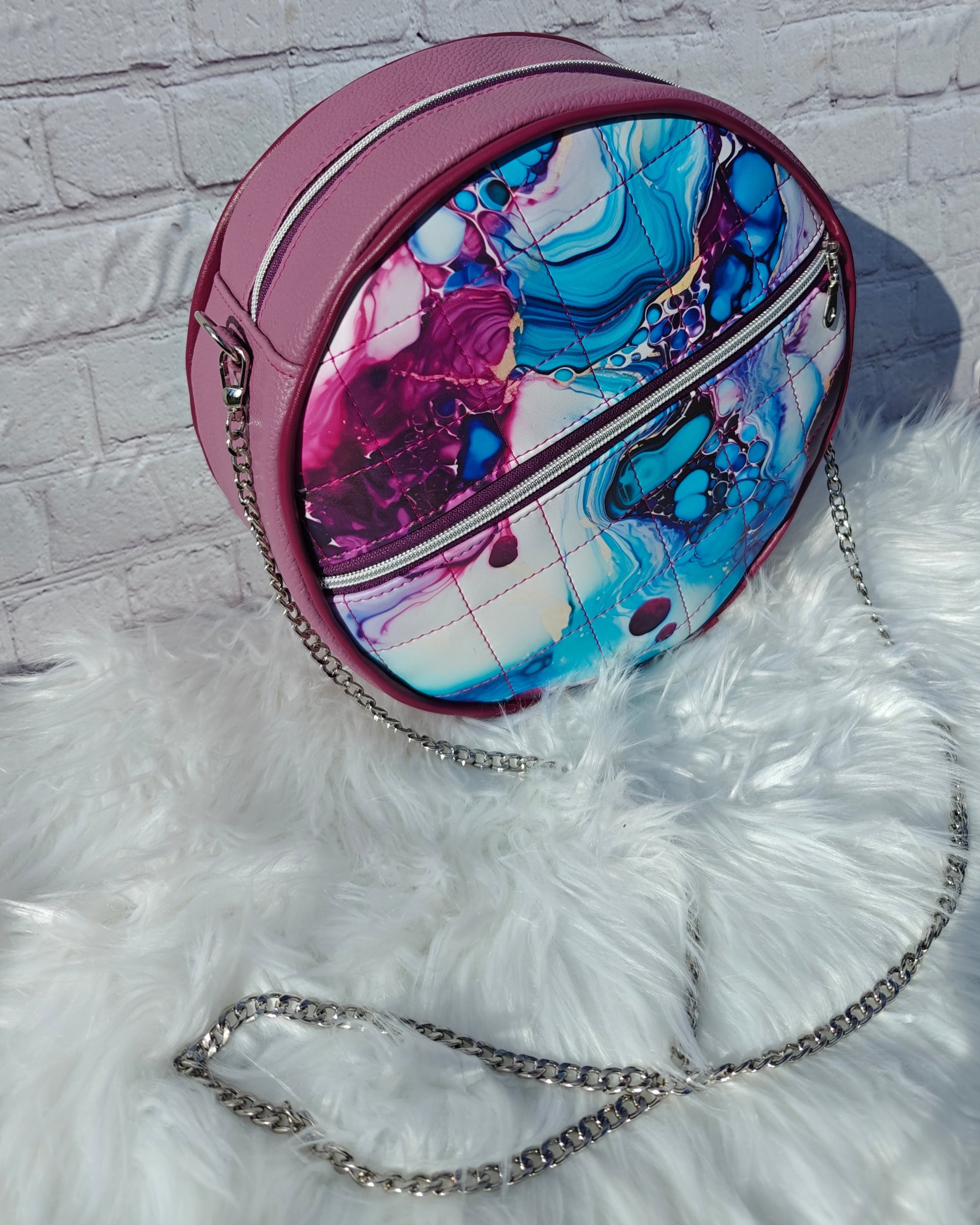 Ellie Essential Round Bag sewing pattern in teal marble faux leather with metal piping.