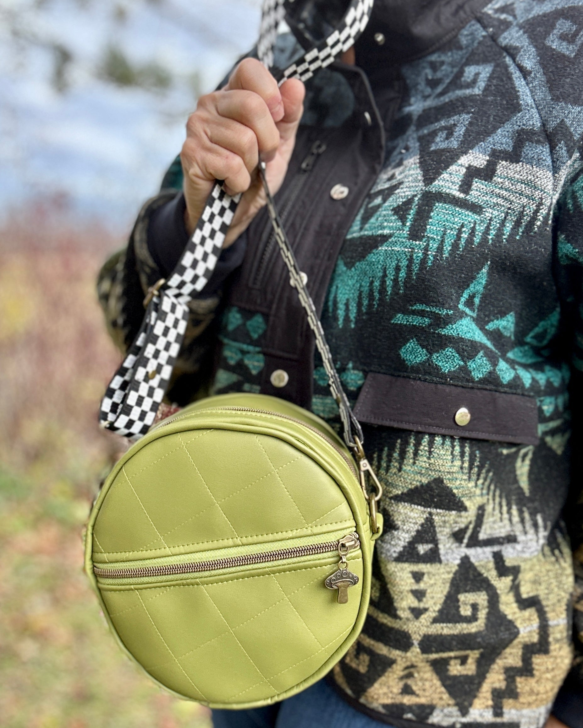 A sewist holding their finished Ellie Essential Round Bag with a smile.