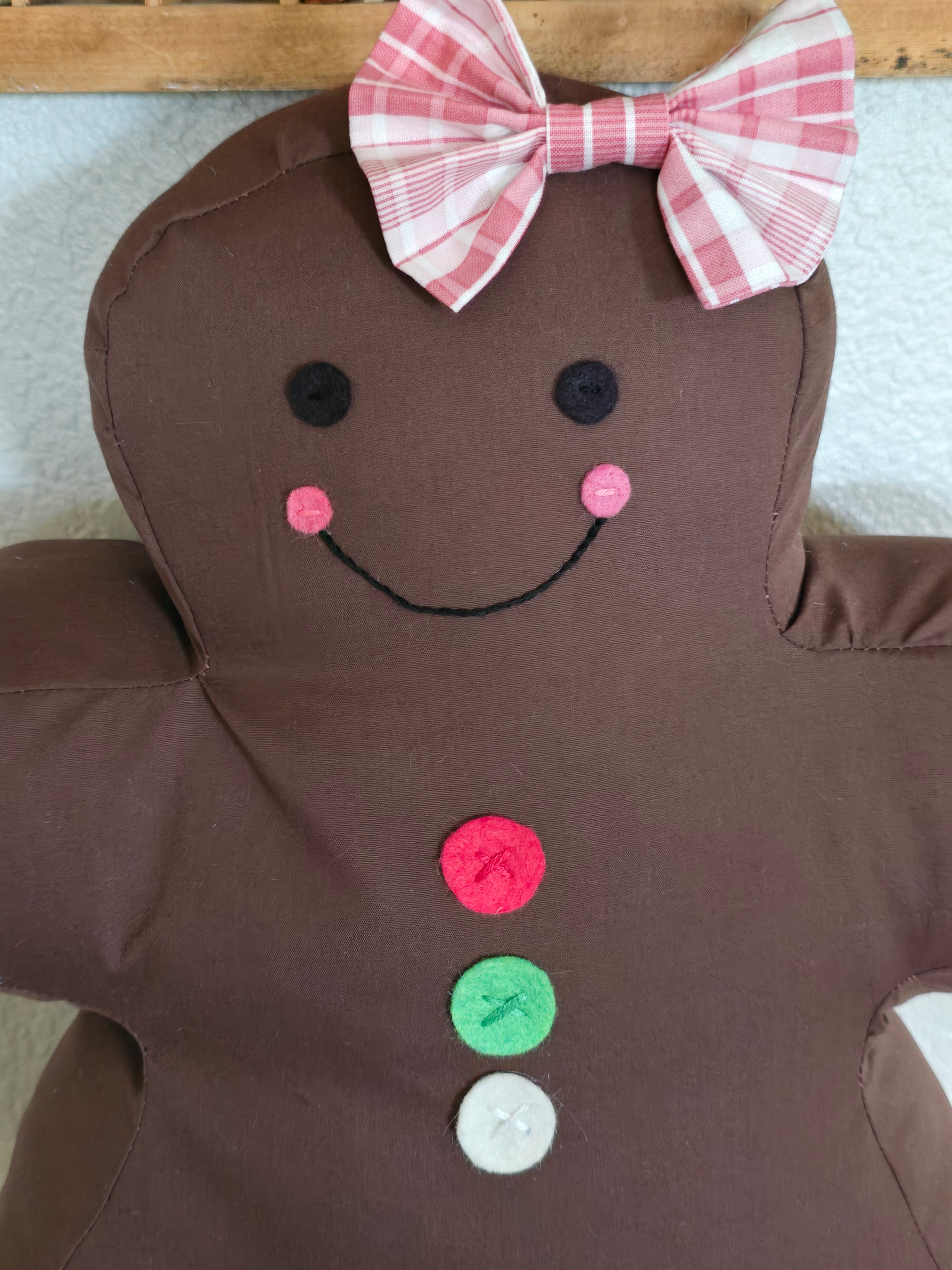 Close-up view of the Jolly Gingerbread pillow face details showing appliqué and stitching.