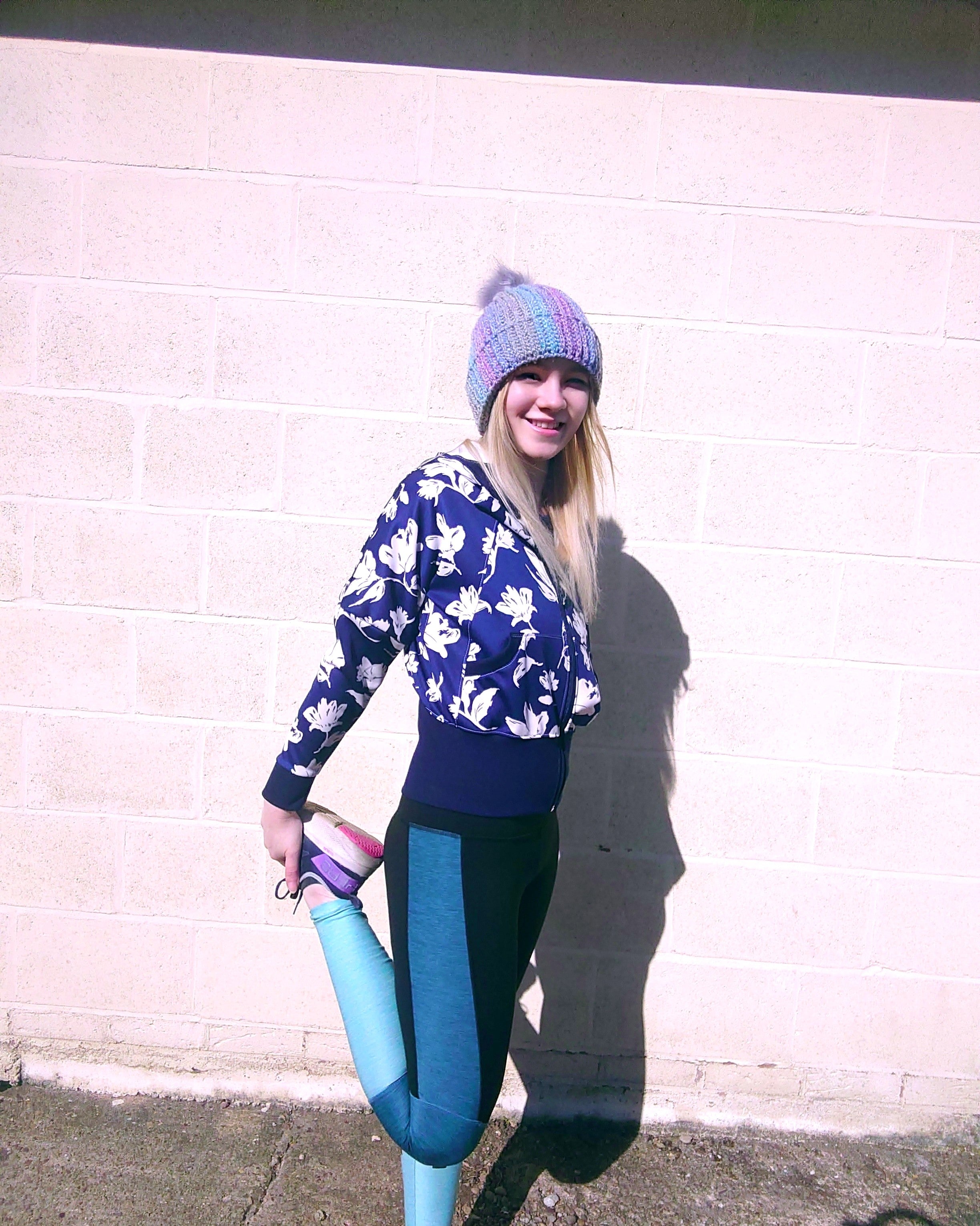 Woman wearing a Scuba knit fabric zip-up athletic jacket with raglan dolman sleeves, kangaroo pocket, and curved waistband. Knit fabric sewing pattern - instant download. High Hip Version.