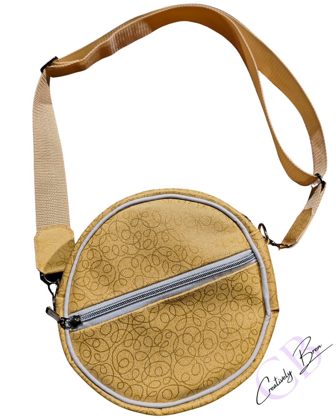 Round beige bag with a patterned surface.