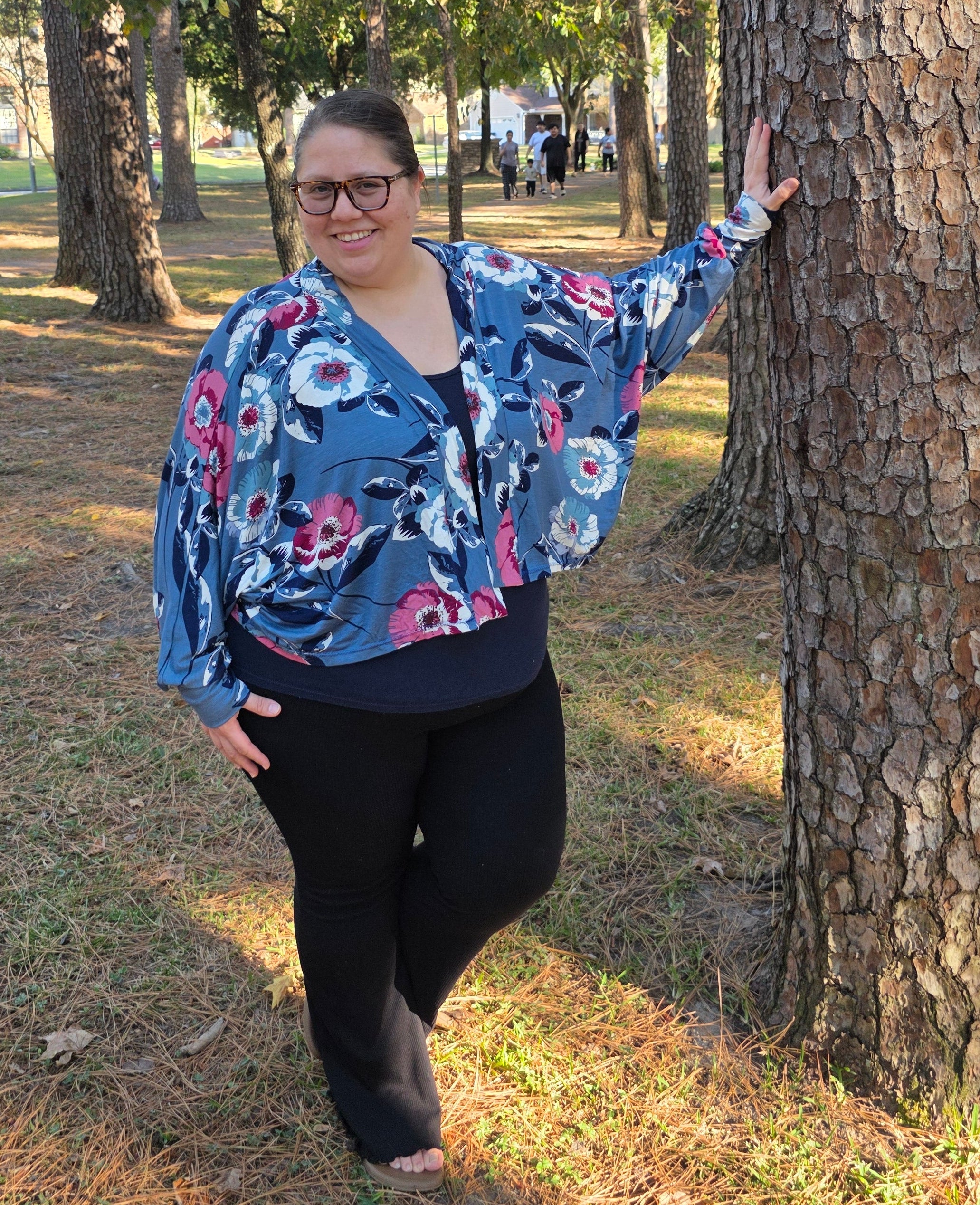 Woman wearing a relaxed fit cardigan with flowing drape and batwing sleeves.
