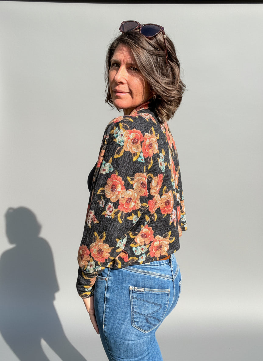 Woman wearing a celeste batwing cardigan with open front batwing sleeves.