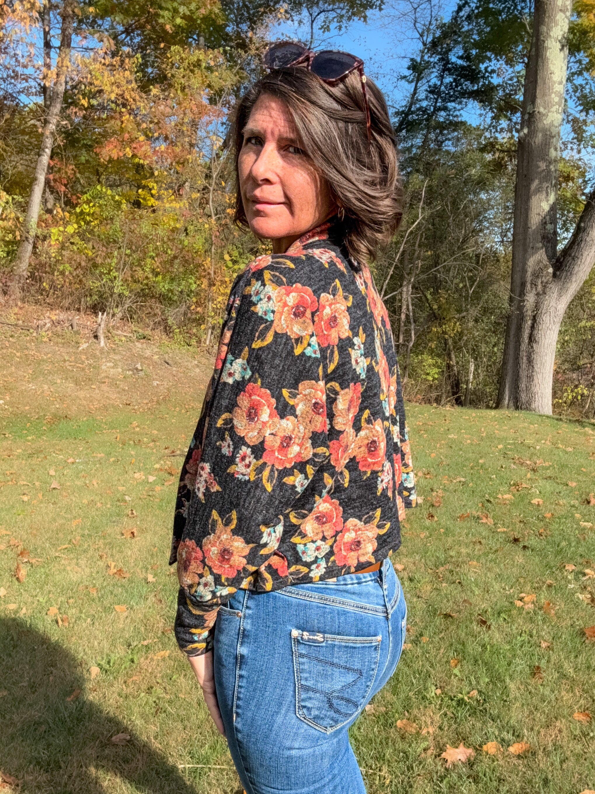 Woman wearing a celeste batwing cardigan with open front batwing sleeves.