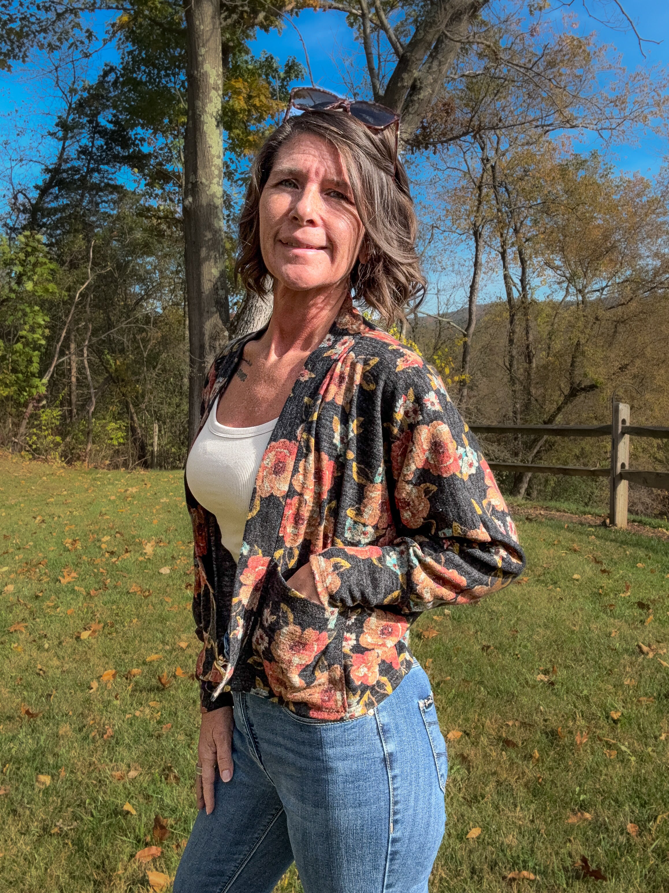 Model wearing a crop floral Celeste Batwing Cardigan with jeans and tee.