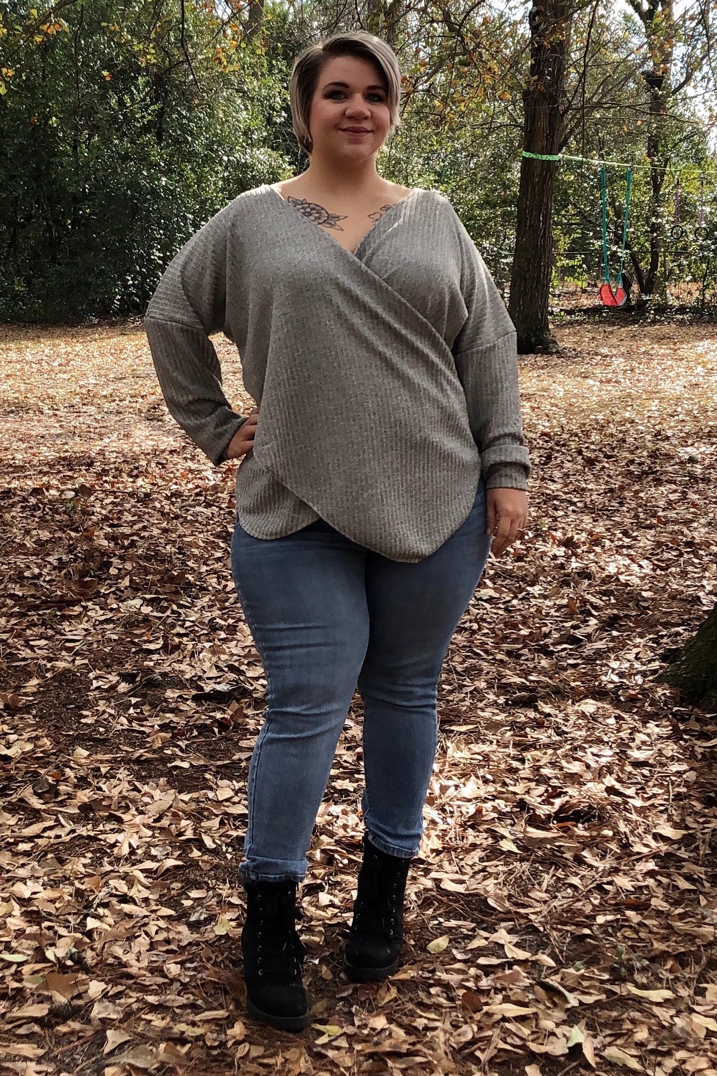 Woman wearing a grey ribbed dolman sleeve wrap sweater and jeans. Sweater was made using the Ellie and Mac pattern for knit fabrics.