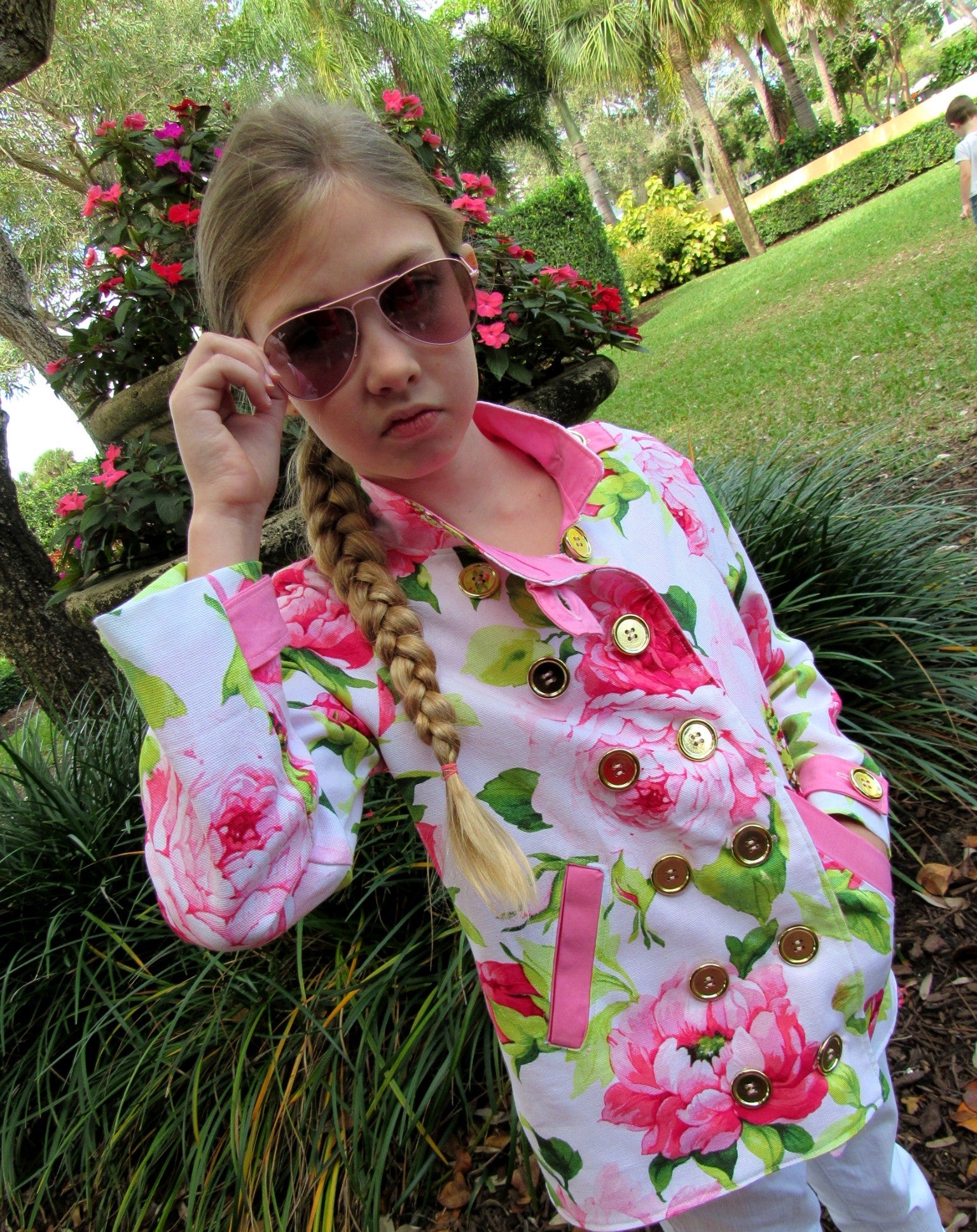 Ellie & Mac Kids Duke Jacket sewing pattern worn by a girl in a pretty pink floral woven fabric with gold button details.