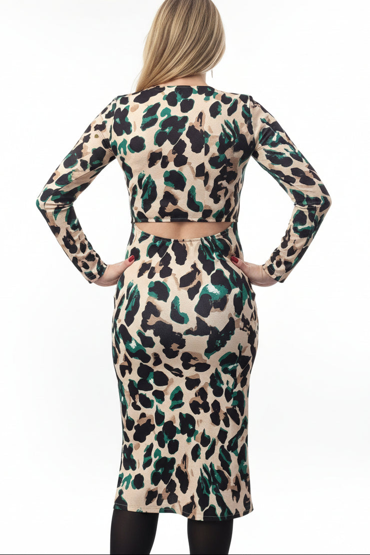 Person wearing a leopard print dress with back cutout and long sleeves standing outdoors.