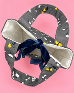 Close-up of fabric gift bag handles, lining and ribbon construction