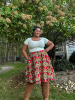 Woman in a patterned skirt standing outdoors with greenery in the background. The skirt is made using the Sadie Bubble Skirt PDF sewing pattern. It includes a projector file, A0 copyshop file, and A4 and Letter print file. Full-length sew-along video tutorial is included. 
