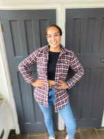 Model smiling in front of a door wearing a hip length shacket made using the Connie Casual Shacket PDF sewing pattern by Ellie and Mac Sewing patterns.