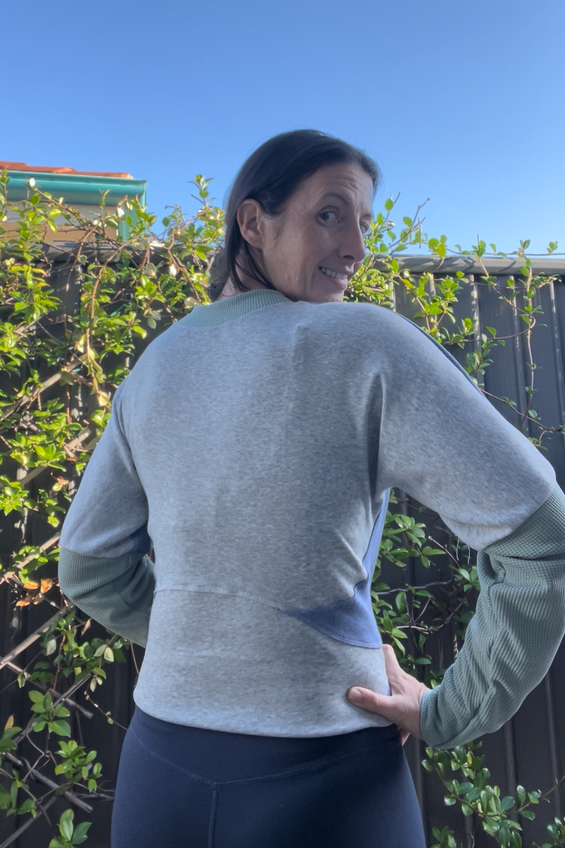 Woman wearing a zip up athletic jacket showing the back curved waistband. Sewing pattern for jackets by Ellie and Mac sewing patterns. 