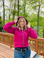 Bright raspberry pink heavy french terry fabric from knitfabric.com sewn into a hooded athletic jacket with zip closure. bishop raglan dolman sleeves. Cropped version.