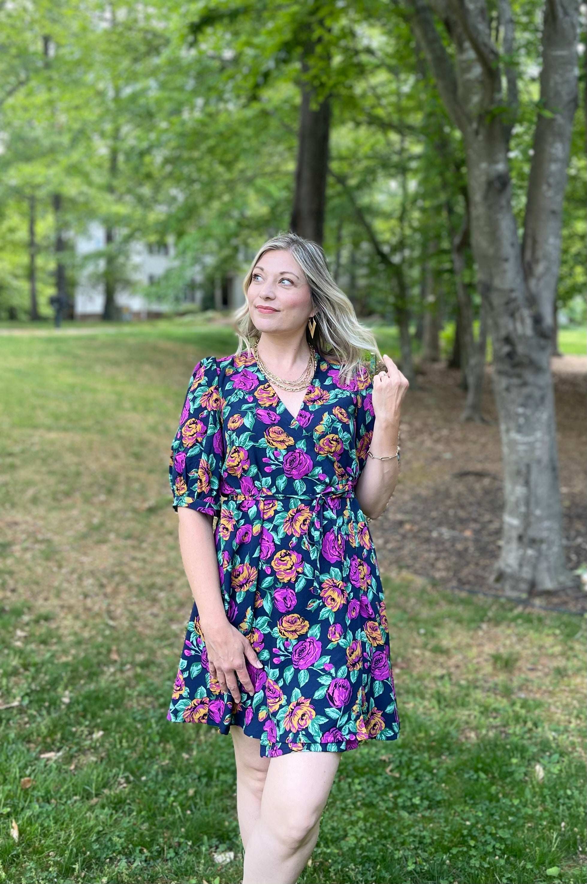 Floral puff elbow sleeve woven wrap dress sewing pattern on a female model. Mid-thigh length.