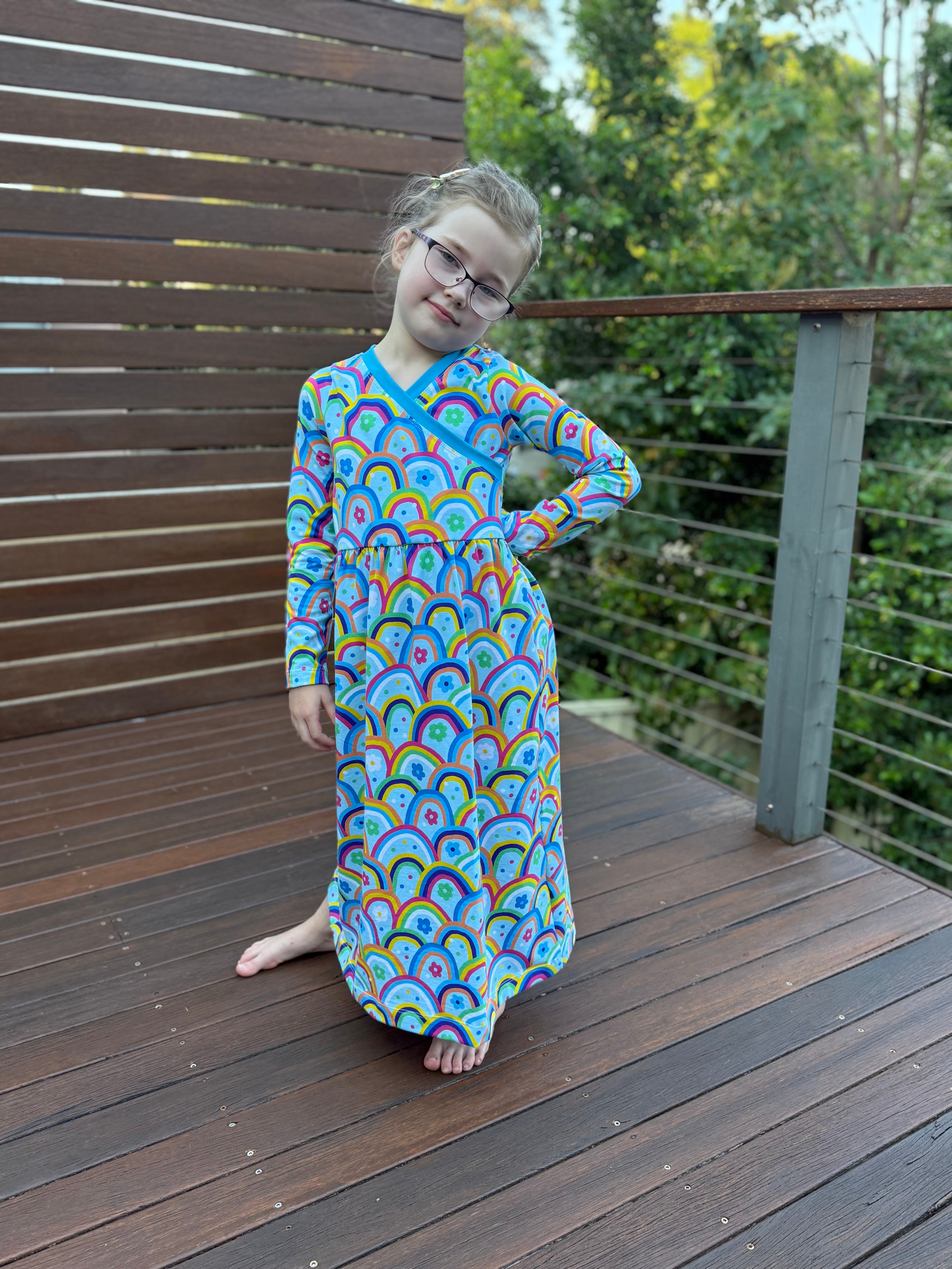 Cute maxi dress for kids. Easy sewing patterns for beginners. Knit dress pattern. Long sleeves with rainbow fabric.
