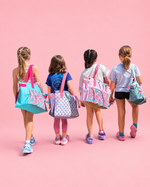Four children with colorful bags on a pink background made using Ellie and Mac PDF award winning sewing patterns that are perfect for confident beginners. All patterns include A4, letter, A0 print files, projector files, and full sew along video tutorial. 