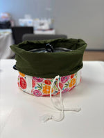 Floral fabric slow cooker carrier bag open to show the pouch folded down over the cooker to allow you to open the lid and serve the food without removing the cooker from the bag. Great for tailgating parties, potlucks, holiday gatherings, and gift giving.