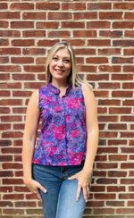 PDF sewing patterns for woven fabrics. Button down sleeveless top modeled by a blond woman. Floral voile fabric. Hidden placket with ruffle collar detail. 