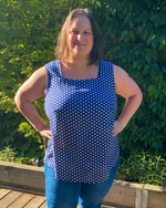 Sleeveless woven blouse paired with trousers for chic outfit