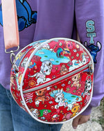 Child holding a red DIY lunch bag with cartoon designs outdoors. Ellie and mac sewing patterns.