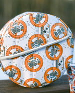 Round purse pattern with BB-8 design on a wooden surface with a blurred natural background. Front zip pocket.