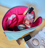 Tessa Toiletry Pouch filled with travel items demonstrating storage capacity.