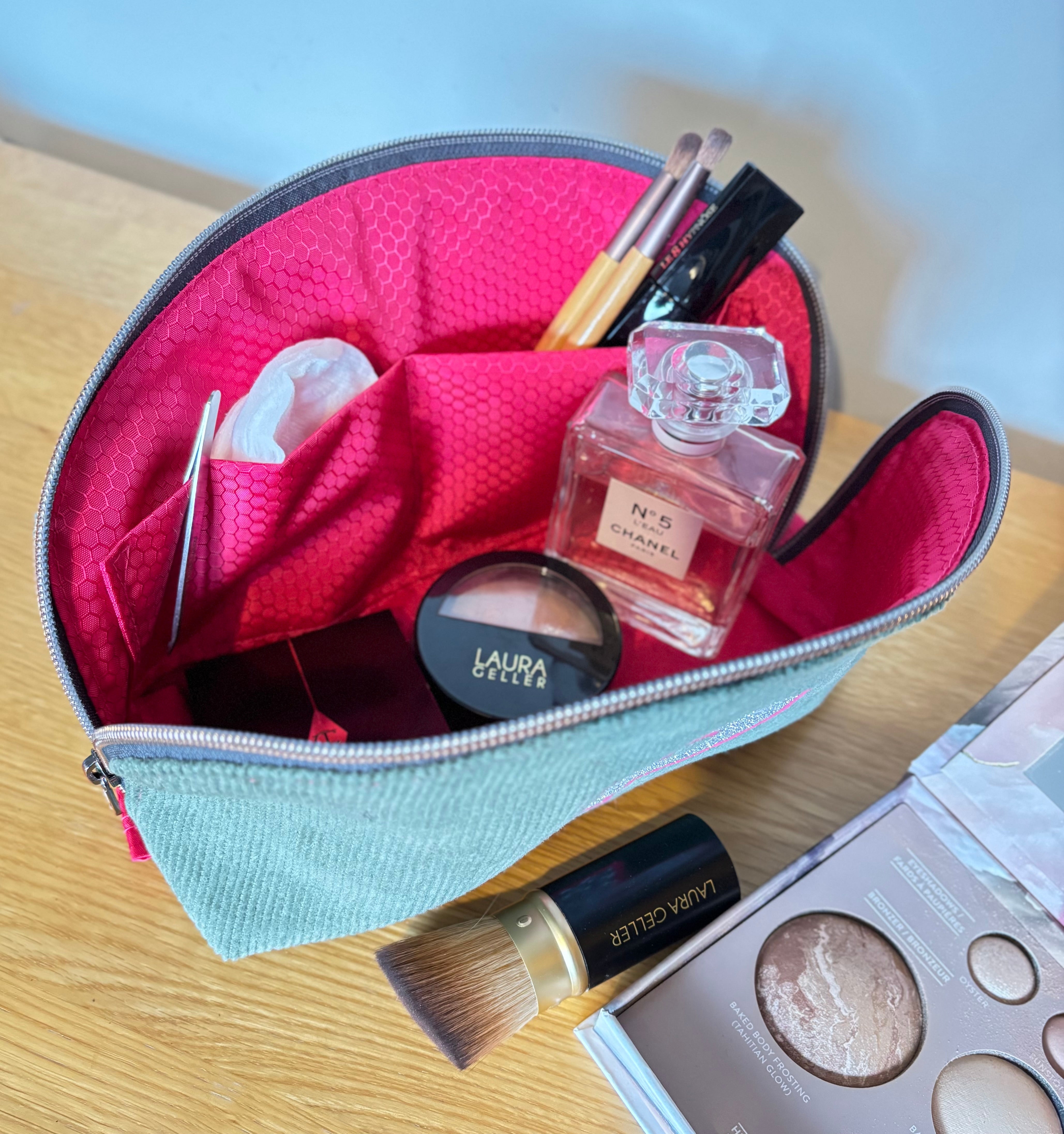 Tessa Toiletry Pouch filled with travel items demonstrating storage capacity.