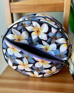 Handcrafted round vinyl bag in black quilted vinyl with black  hardware and hidden strap connectors.