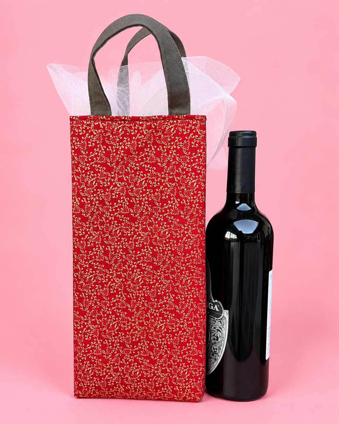 Handmade fabric wine bottle gift bag with handle and structured sides. 