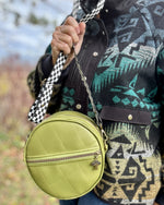 A sewist holding their finished Ellie Essential Round Bag with a smile.