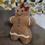 Side angle view of the Gingerbread pillow highlighting stuffed shape and silhouette.