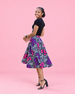 Side view of the Mila woven skirt showing its flowing paneled shape
