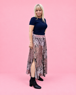 Side view of the Mila woven skirt showing its flowing paneled shape